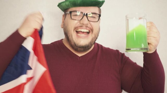 Portrait of overjoyed bearded man standing with excited expression, raising fists, screaming, shouting yeah, celebrating his victory, success.