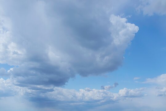 Blue sky with dramatic clouds. Cloudy daytime sky with soft clouds.