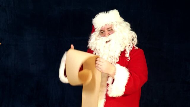 Santa Claus looking at long list with children desire