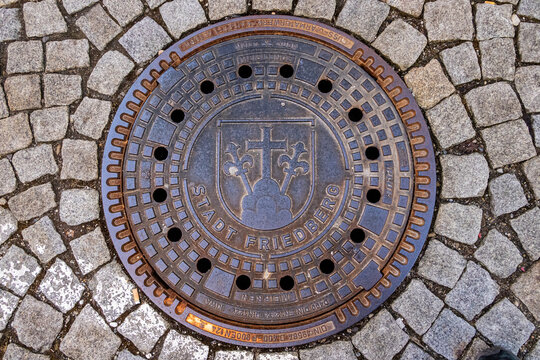 Historic manhole cover with city coat of arms of Friedberg Bavaria Germany, Deutschland, Friedberg, 07.03.2026