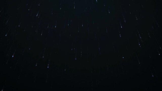 Falling Water Droplets or Rain Streaks on a Dark Background image photo