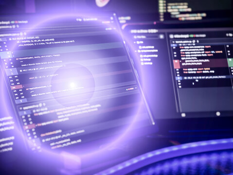 programming code on multiple monitors with a glowing purple digital effect, representing futuristic software development.