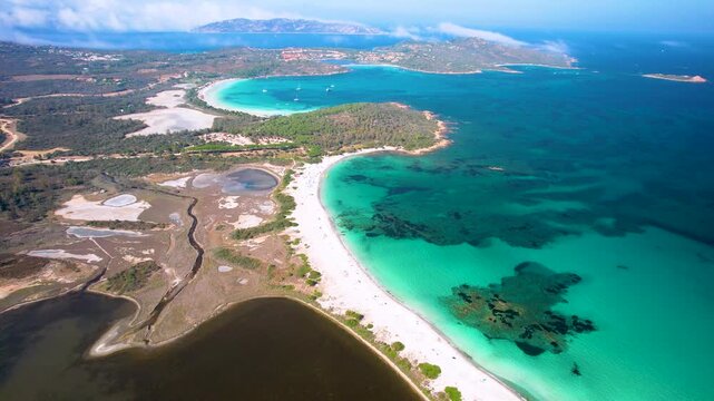 Sardinia Lu Impostu and Brandinchi beach 4k drone. European Caribbean turquoise bay with yachts and salt lake in Italy. Mediterranean tropical paradise aerial scenery