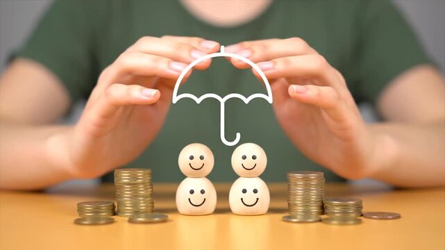 Happy snowman family with coins under umbrella saving money concept on wooden table
