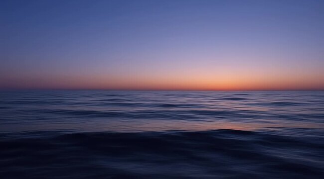 A serene ocean at twilight, with gentle waves under a gradient sky