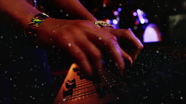 Sound engineer hands finger pressing fader adjusting console with particles over hands for live mix