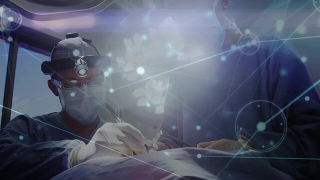 Performing surgeon wearing headlamp post drape leaning in OR using scalpel under node overlay
