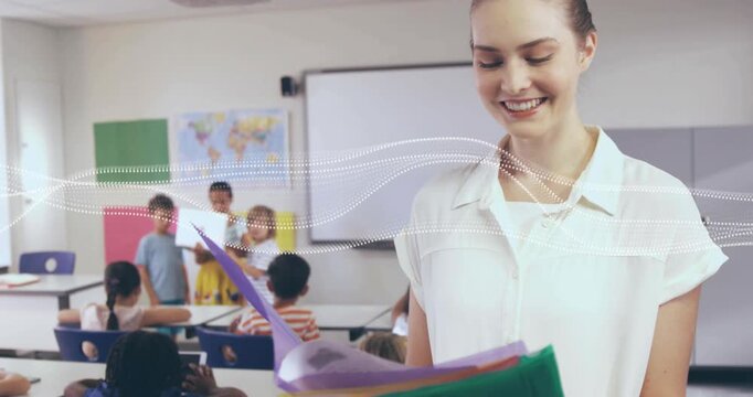 Teacher flipping folders while students raising tablet and starting class display for education