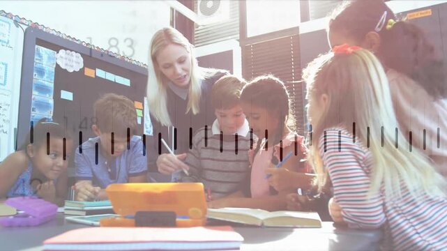 Teacher leaning and pointing stylus, initiating lesson, guiding students studying tablet and book