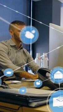 Vertical video: Alerts sparking mail and cloud icons forming net around man typing for office