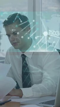 Vertical video: Analyst reading papers tech overlay forming charts on papers while verifying data