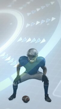 Vertical video: Football player releasing ball, adjusting stance for snap with arrows marking hands
