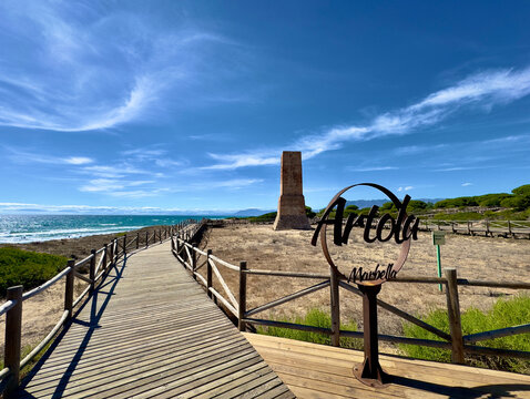 Torre Ladrones (Thieves Tower) at the coast of the Mediterranean Sea near Marbella in the light of a wonderful summer day with blue sky, Cabopino, Costa del Sol, Andalusia, Spain