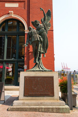 Naklejka premium Bronze statue of a dead Canadian soldier of the First or Second World Wars carried by an Angel in front of the Waterfront Station in Downtown Vancouver, British Columbia, Canada