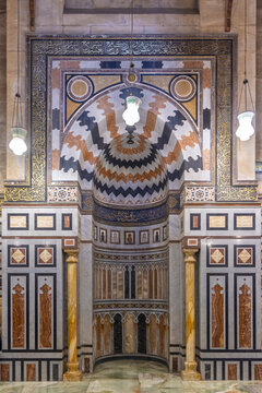 Ornate Islamic mihrab and mosque interior with marble inlay in Cairo, Egypt, traditional architecture