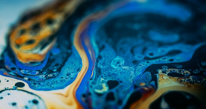 Paint water. Color fluid. Defocused orange blue purple acrylic bubbles chemical round fuel oil droplets wave on abstract art background.