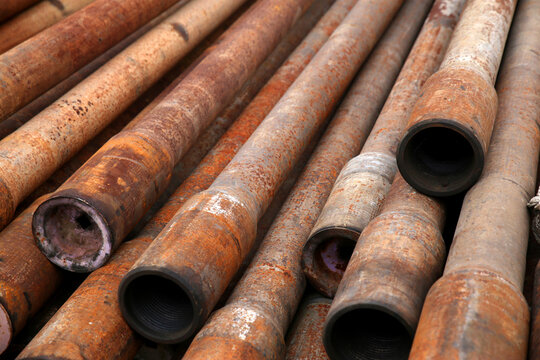 Corroded industrial drill pipes at wellsite