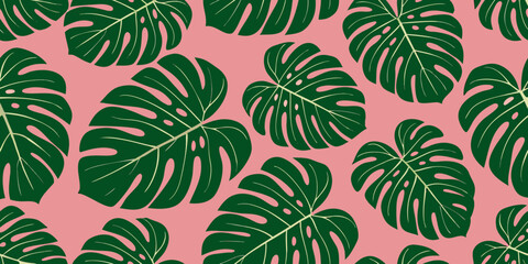 A seamless pattern of vibrant monstera leaves on a pink background © Biplab