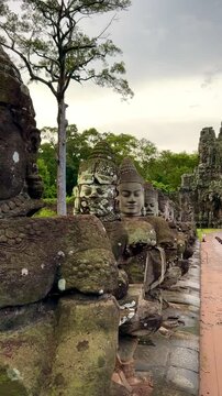 Ancient Stone Gate with Bridge and Hindu Carvings (Siem Reap, Cambodia)