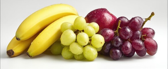 Fresh and Vibrant Assortment of Bananas, Green Grapes, Red Grapes, and an Apple on a White Background.