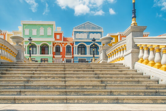 Stone staircase with classical balustrades leading to colorful Mediterranean style buildings on Phu Quoc island, Vietnam. Pastel facades, decorative street lamps and resort architecture