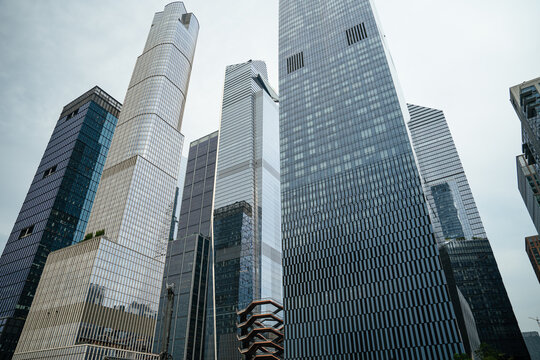 New York City, New York, USA - 08.02.2024: A dramatic low angle perspective highlights towering glass skyscrapers in Manhattan, New York City. The modern financial district architecture reflects urban