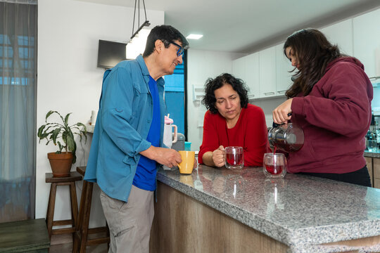 Latino family serving coffee in the morning and sharing breakfast.