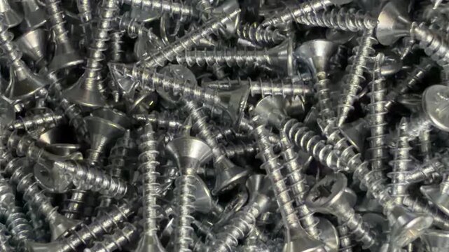 construction hardware in close-up. parts for furniture production and assembly. screws with a solid background.
