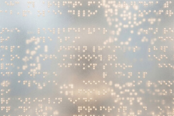 Abstract glowing braille dots texture on translucent glass