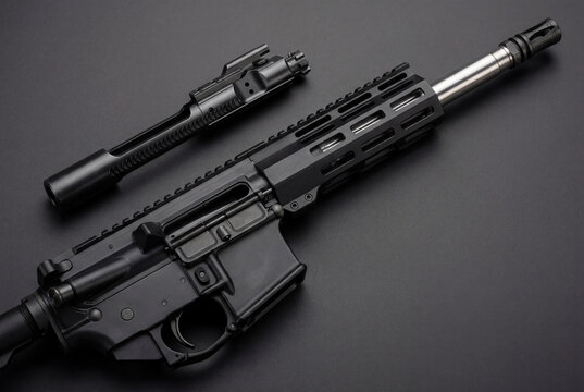 Disassembled AR 15 rifle with bolt carrier group on a black background