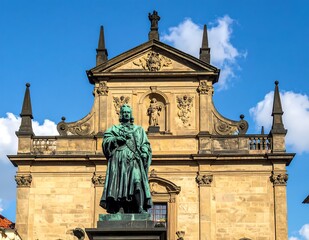 Obraz premium Statue of Charles IV in Prague with Church of St. Francis of Assisi.