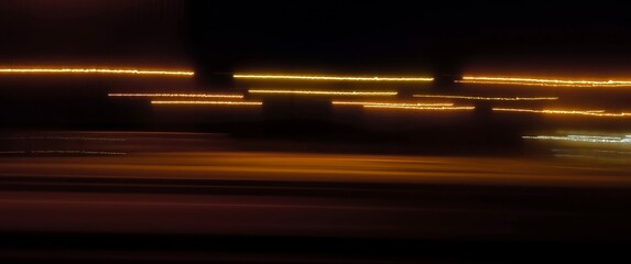 Obraz premium Abstract long exposure photograph of colorful neon light trails on dark background. Perfect for presentations, websites, posters, branding. High resolution with plenty of copy space 