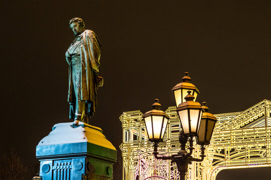 Moscow, Russia - January 7, 2026: Monument to Alexander Pushkin on Pushkinskaya Square and christmas illumination in background in winter night