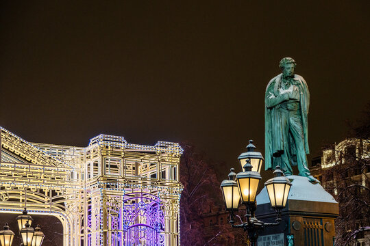 Moscow, Russia - January 7, 2026: Alexander Pushkin Statue on Pushkinskaya Square and christmas illumination in background in winter night