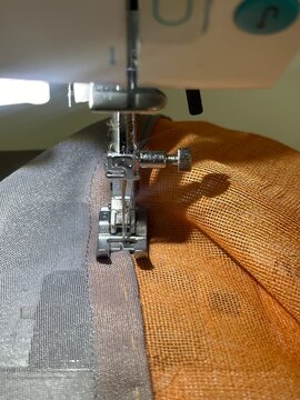 Close-up of Sewing Machine Needle Stitching Through Fabric, Handcraft 