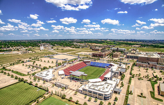 Aerial view of Soccer Stadium in Frisco, Texas during beautiful day with sun and clouds.
