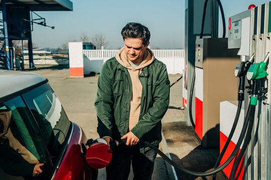 A man fills his car with gas during the fuel crisis