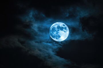 Full Blue Moon Shines Brightly Through Wispy Clouds in Dark Night Sky.