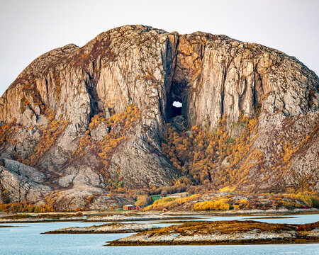 Torghatten mountain in Norway. Nature's Eye: The Enigmatic Hole in the Mountain. Torghatten is a granite dome on the island of Torget in Nordland county, Norway. 