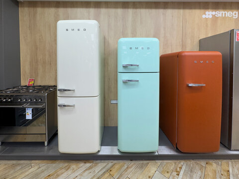 Sheffield, Yorkshire, united kingdom, December 27th 2025 Row Of Retro Smeg Refrigerators In Pastel Colors Styled In A Modern Kitchen Showroom Display