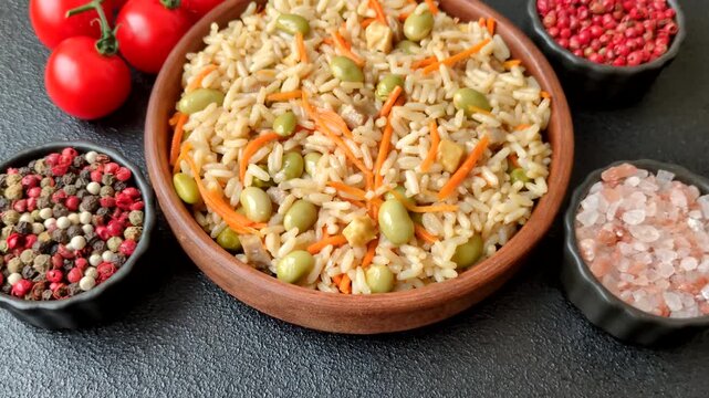 Asian food with rice, edamame, carrots, tofu, and spices. Rice with edamame and carrots as a food background for your design