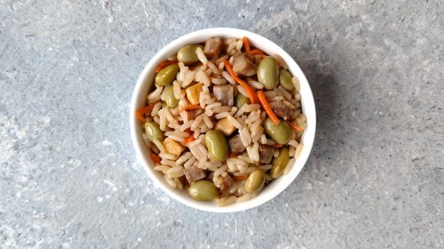 Asian food with rice, edamame, carrots, tofu, and spices. Rice with edamame and carrots as a food background for your design