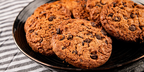 Fototapeta premium Chocolate cookies with chocolate chips sweet dessert homemade baking tasty snack fresh gourmet food background on the table rustic food top view copy space marketing concept photo