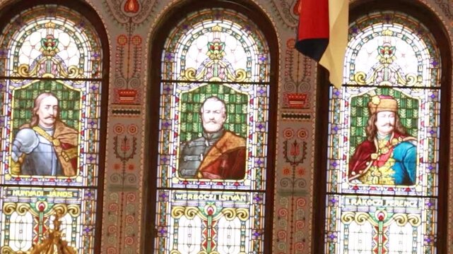 Symmetrical static shot of three stained glass windows in historic synagogue