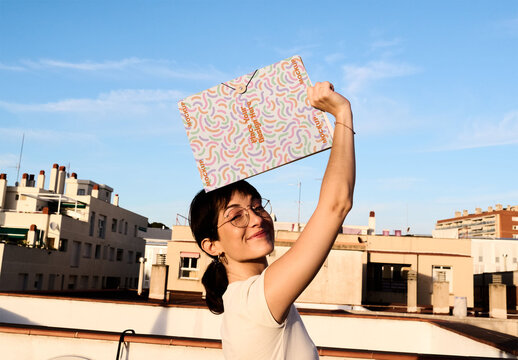 Real photo of woman Holding a Folder Above Their Head. PSD template mockup.