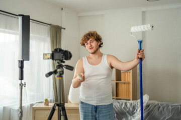 Male v-logger recording home renovation painting tutorial
