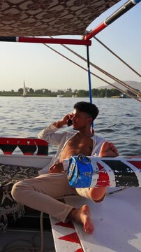Man sailing on felucca in luxor egyptt