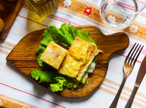 Flia served on lettuce salad leaf on wooden board, popular dish of Albanian and Kosovan cuisine