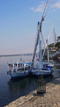 Scenic Nile River Waterfront with Felucca Boats and Traditional Egyptian Tea