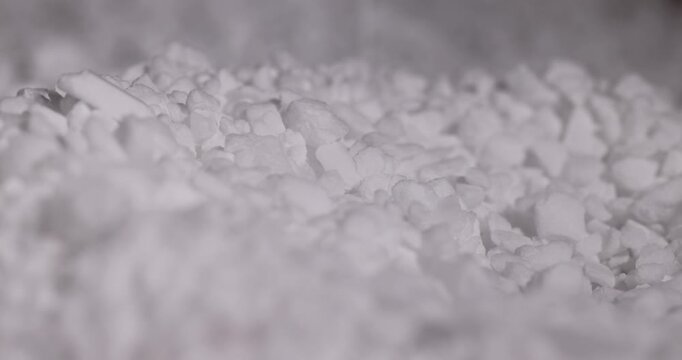 white coarse salt that is used in dishwashers to improve and soften water, white coarse crystals of special salt for dishwashers for good and long-lasting dishwasher operation